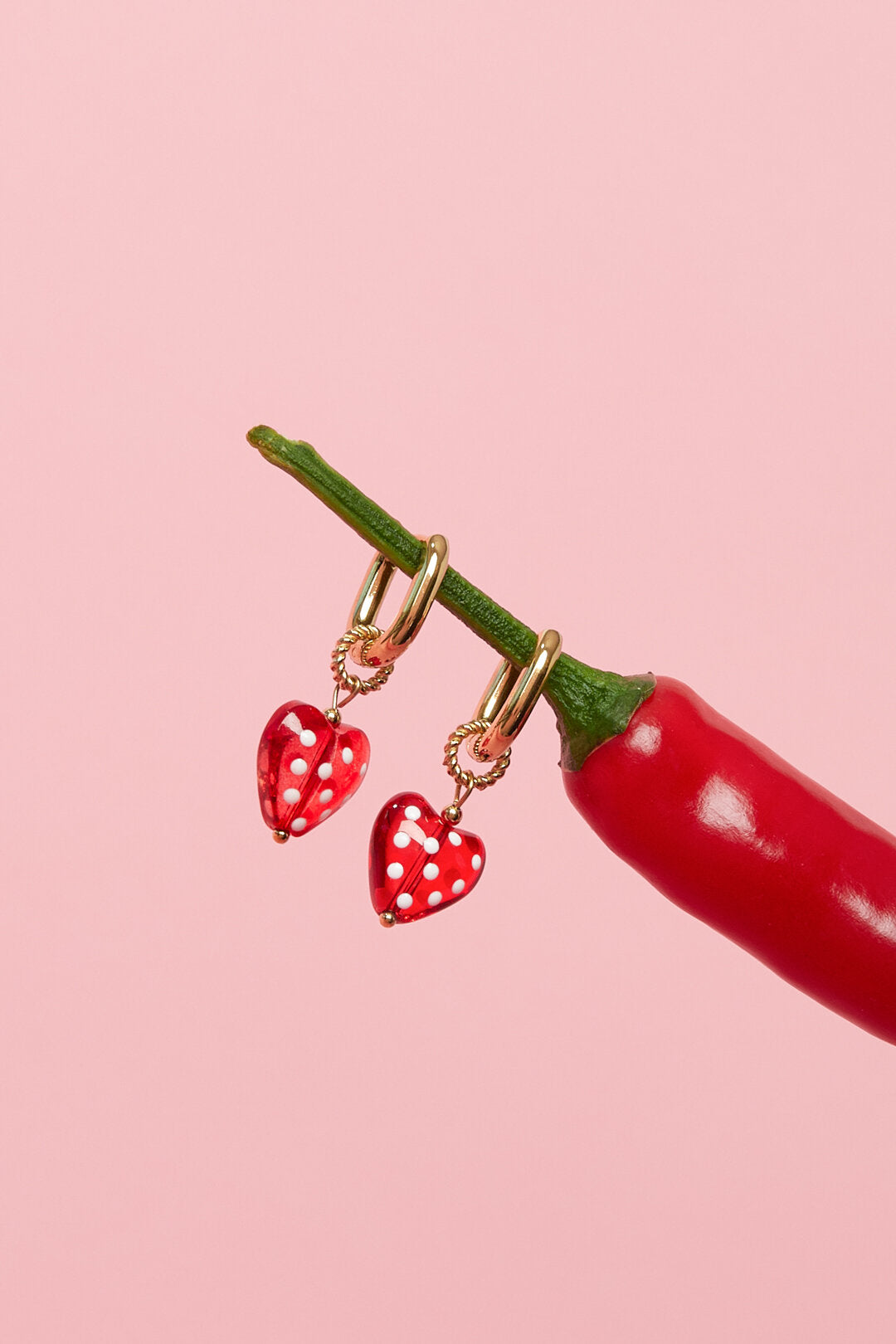 Earrings with dangling hearts with dots
