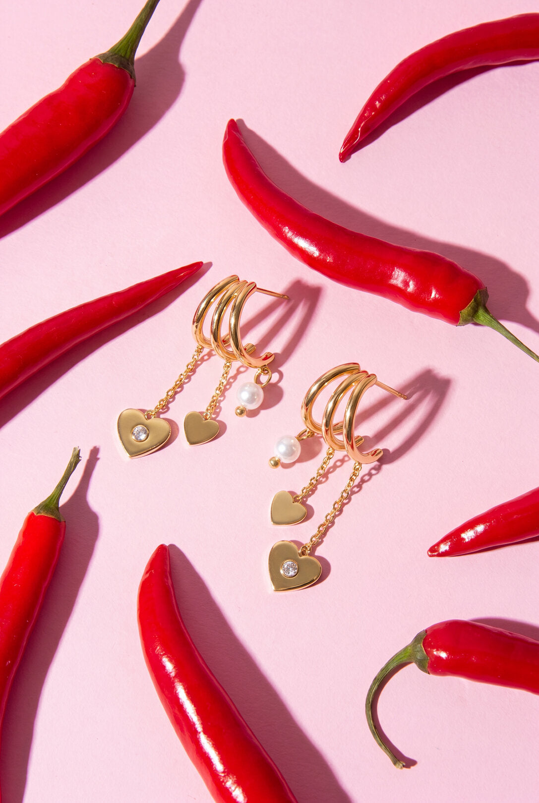 Triple earrings with heart pendants and pearl