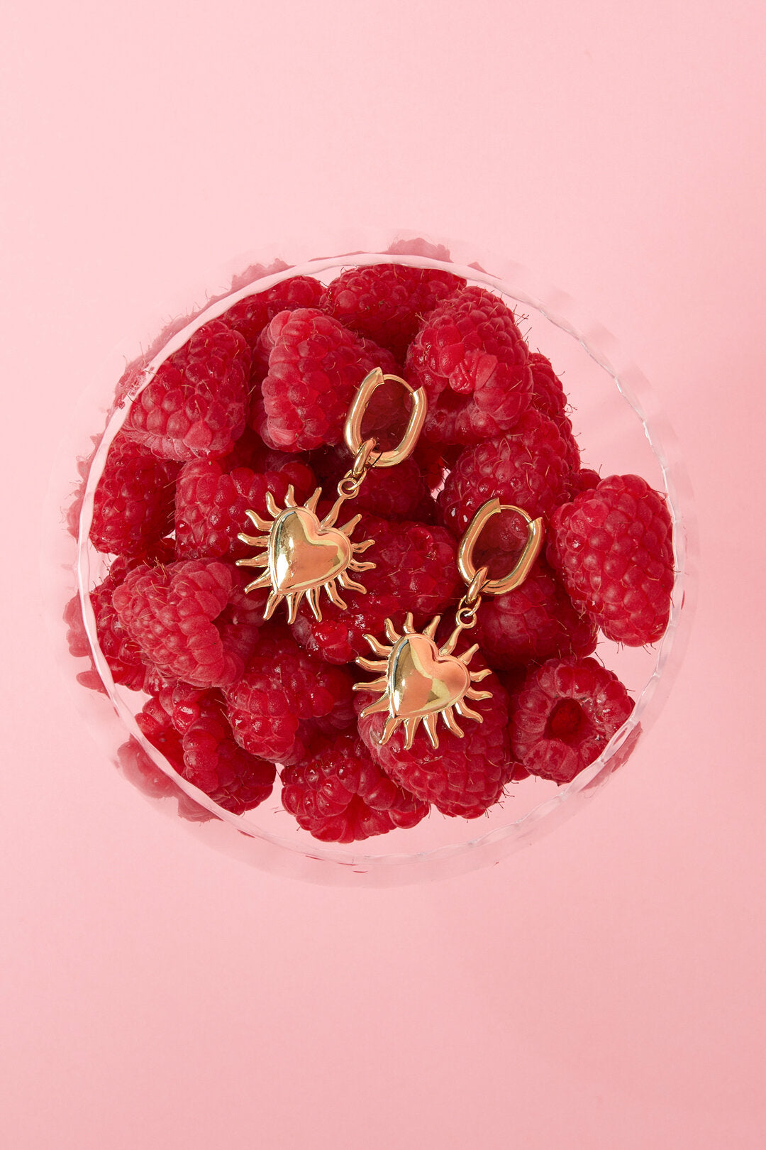 Earrings with dangling hearts and sunbeams